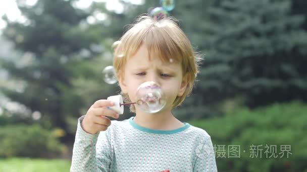 beautiful little girl with soap bubbles. Slow motion. Close up