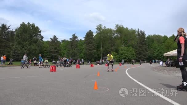 Amateur roller skater team relay-race relay with barriers. 4K