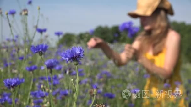 woman in yellow dress pick flower in bouquet. Woman in blur. 4K