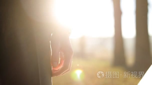 Close up of wedding couple holding hands at sunset