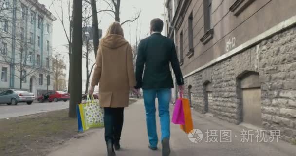 Couple enjoying the walk after good shopping