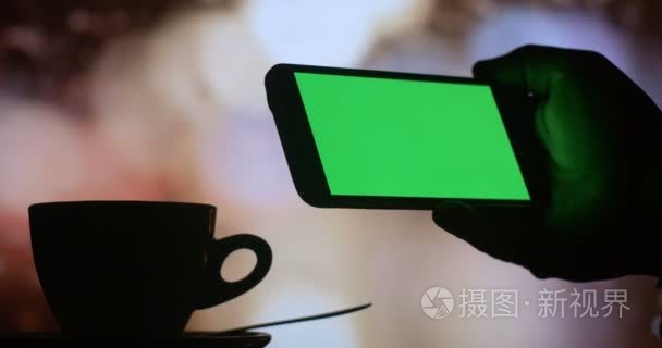 Man using smart phone and drinking coffee tea