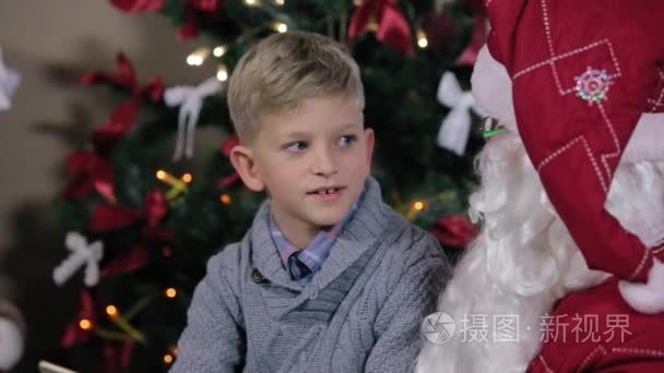 男孩坐在圣诞老人的膝盖上沟通视频