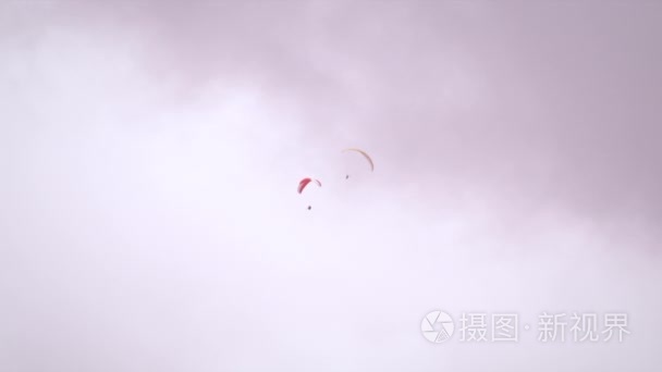 paragliders moving closely to each other