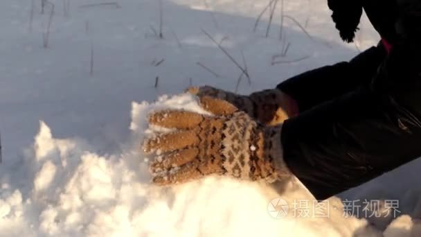 The girl start makes snowman in winter forest.  First part.