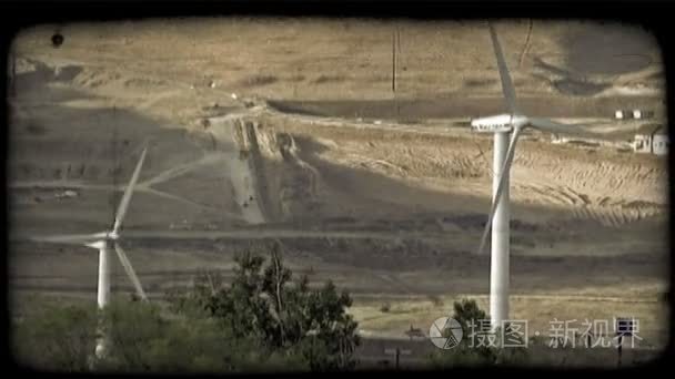 Two windmills by mountain. Vintage stylized video clip.