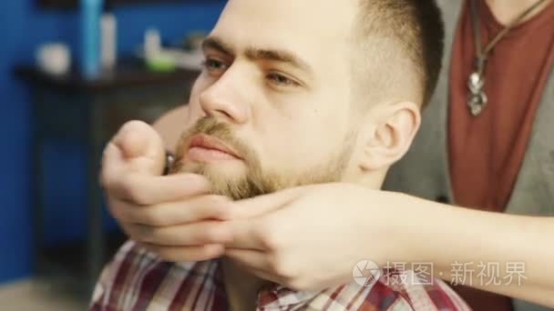 Barber rubs his beard client butter