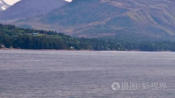 Time-lapse view of houses along the shoreline of the Inside Pass