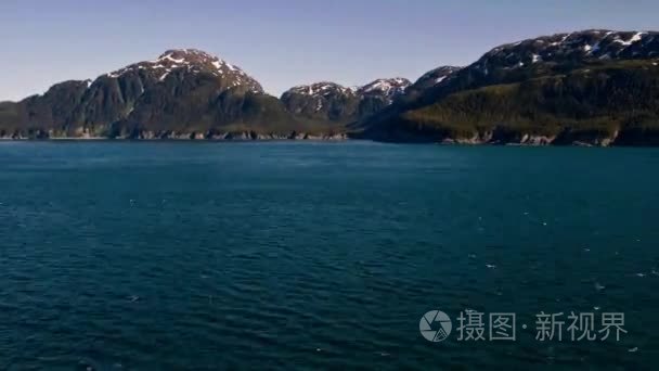 Traveling time-lapse of mountains around the ocean near Glacier 