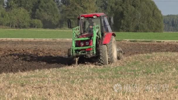 Farmer driving tractor in cabin plow agriculture stubble field. 