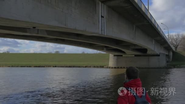 Man is Looking at Concrete Old Bridge Water Flows Under Bridge G