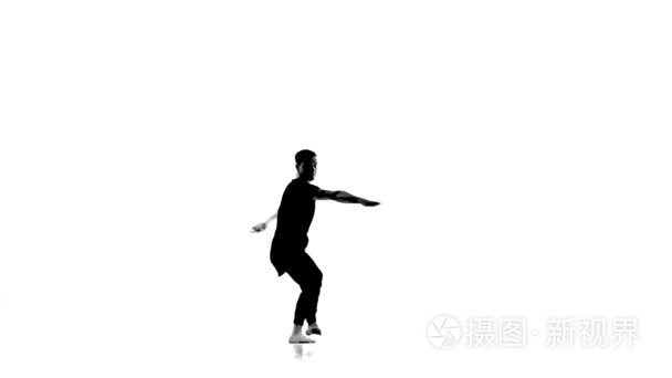 Hip hop dancer showing contemporary movements, white, silhouette