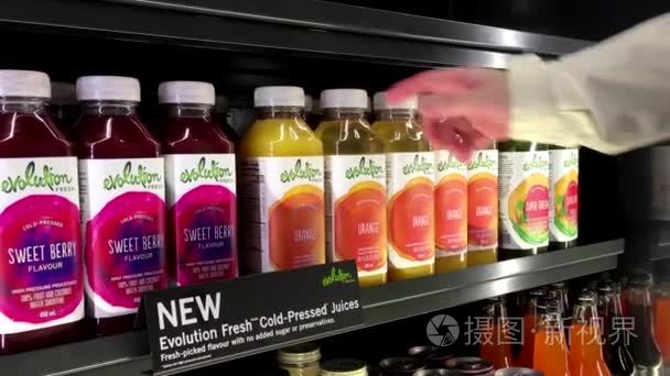 Woman picking erolution orange juice inside Starbucks store