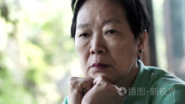 视频的亚洲高级女人用手担心脸思考和悲伤