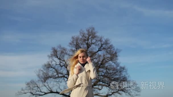 女孩的外套站附近一棵大树视频