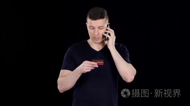 Man reads information from the card. Black