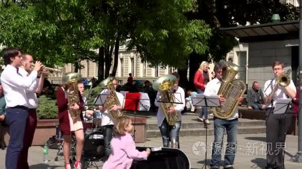 busker musicians band playing with wind instruments in street