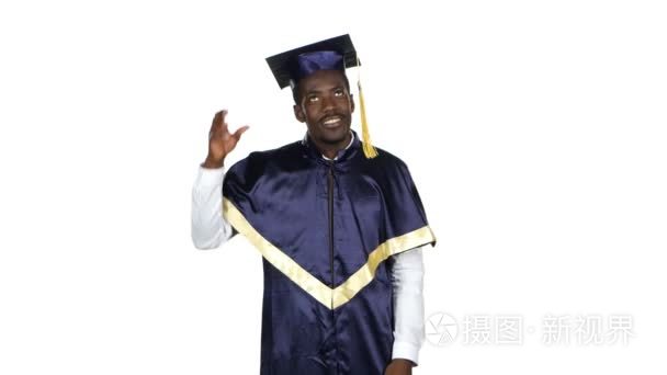 Graduate picks up square academic cap and throws. White