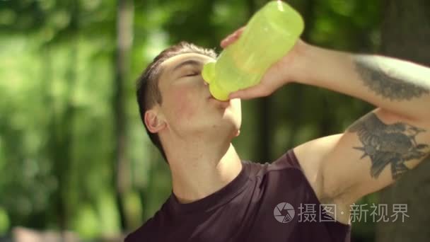 Man drinking water after fitness training. Fitness man drinking 