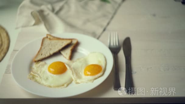 Woman hands put plate with pancake stack on table near plate wit