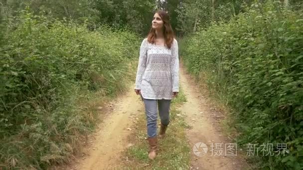 女人走路和在农村公路中微笑视频