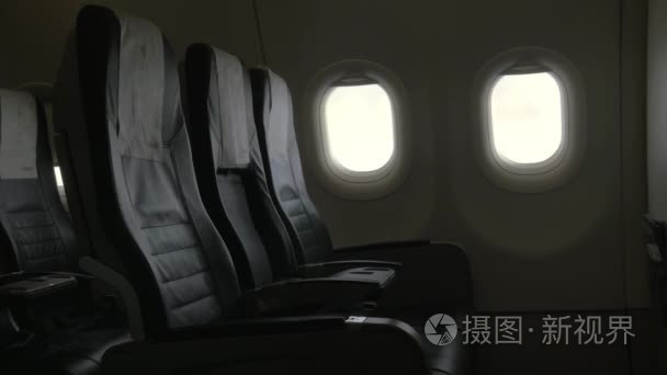 Seen interior decor of plane - black leather chairs and two port