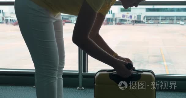 女人重她行李的紧凑秤在机场视频