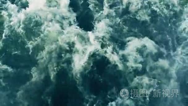 Huge waves stream of deep blue water with foam rising