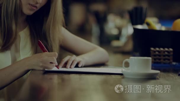 女学生在一家咖啡馆里做作业