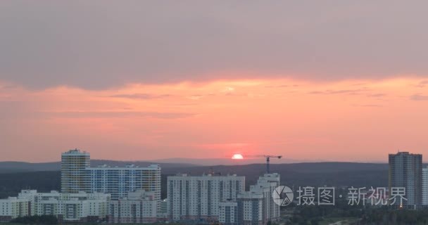 Red sunset in the windows of the light turns on