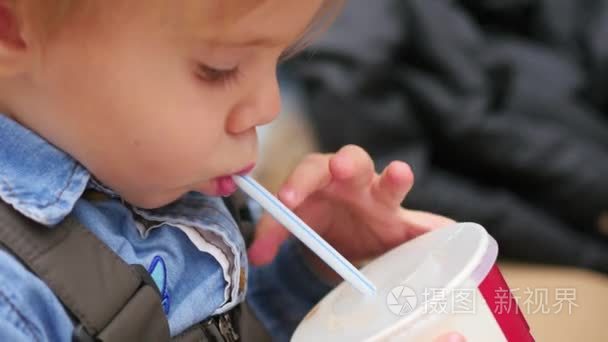 孩子喝从秸秆碳酸的饮料特写视频