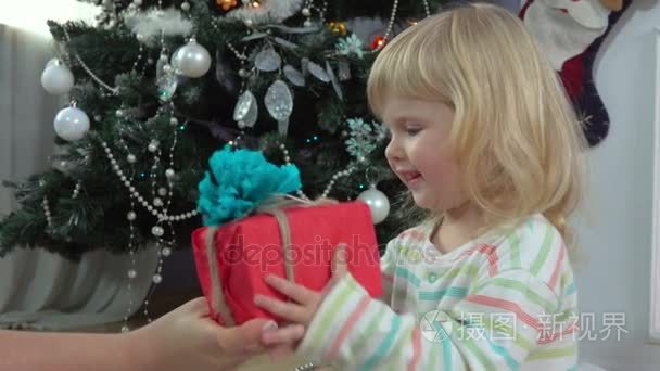 小女孩选择礼物在圣诞节树附近视频