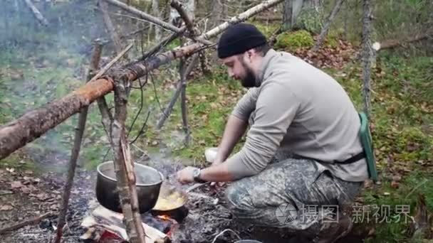 猎人的男人煮食物从火视频