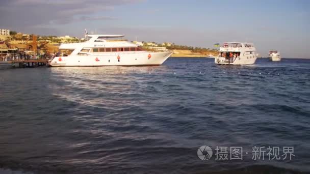 海上邮轮游艇游到码头港口在红海日落