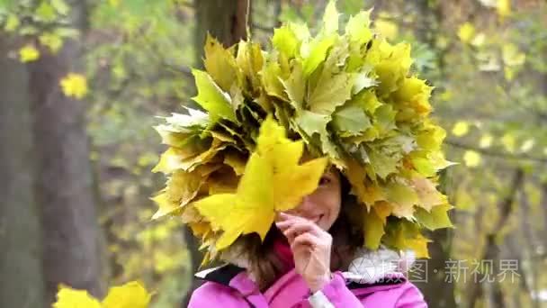 美丽小女孩微笑着与树叶的花环视频