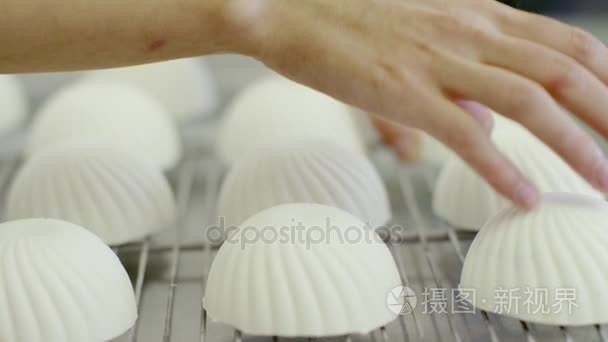 女人的手触摸到的蛋糕，看起来像贝壳