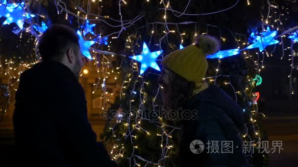 情侣在公园附近的圣诞树亲吻外视频