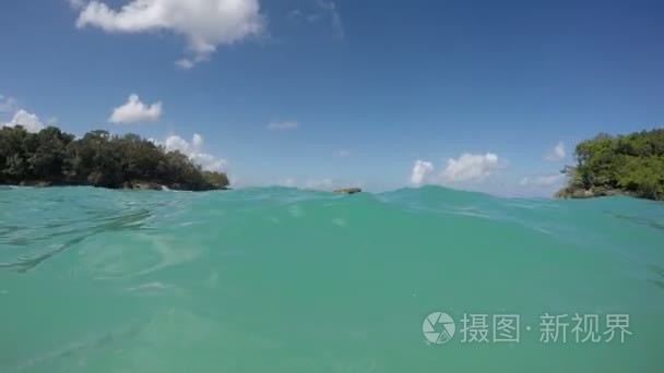 男子游泳碧绿的海水中