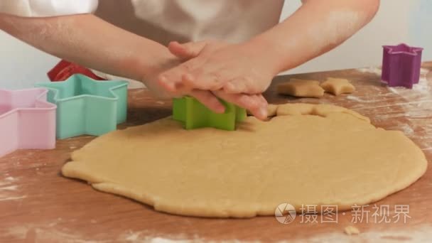 孩子的手做饼干从生面团中恒星形成的关闭