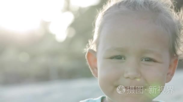 期待着相机在户外，特写一个小女孩的肖像