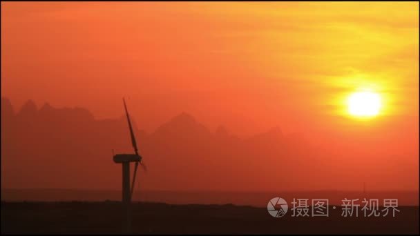 风力涡轮机在落日的天空背景视频