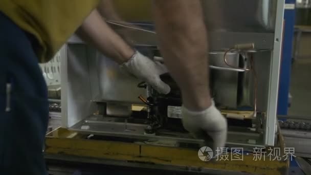 工人把强大的压缩机放在冰箱里视频