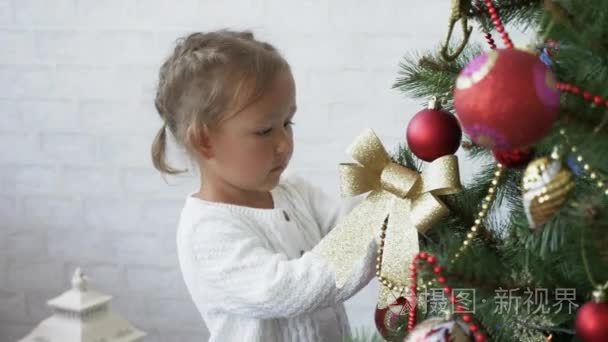 可爱的小女孩装饰圣诞树