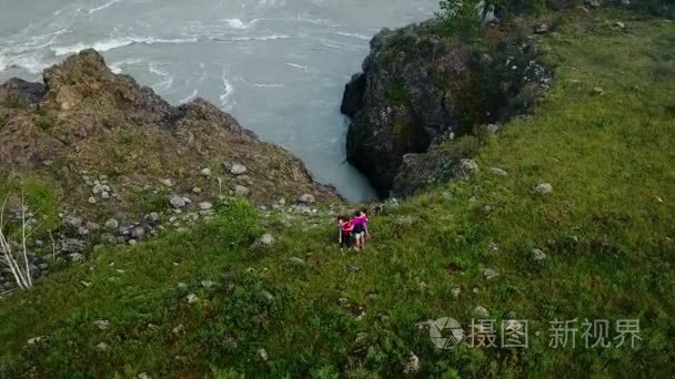 空中。Happyfamily 去露营。父母跟孩子沿山区河流。妈妈和爸爸带女儿在你的手上和展示大自然的美。西伯利亚的阿尔泰山。航空视频