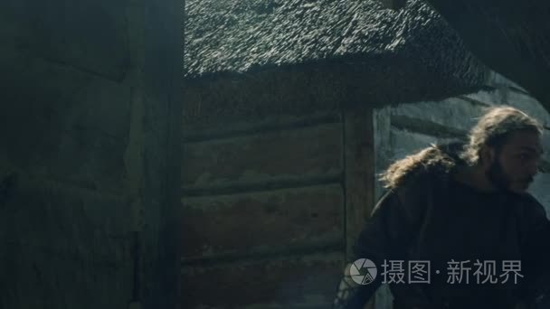 男战士携带一把斧头的画像。中世纪的重演