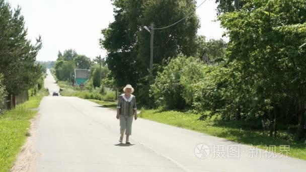 老妇在村庄的路上走视频