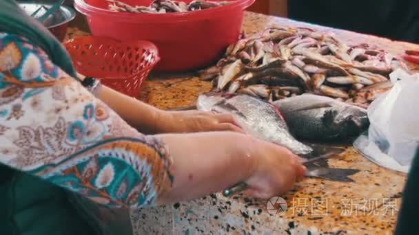 缩放和切割鱼在街市卖鱼的小贩视频