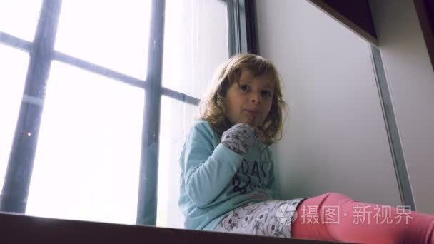小女孩坐在窗台上视频
