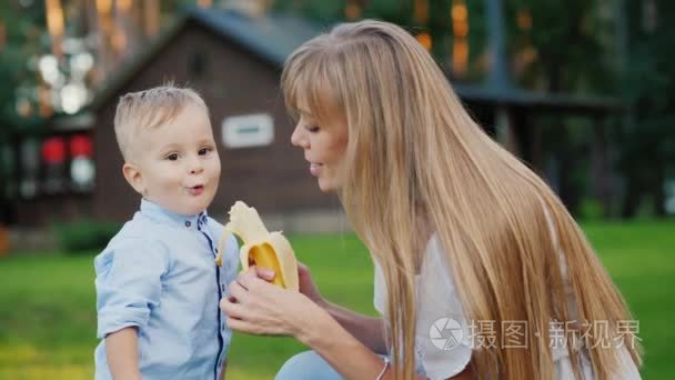 年轻的母亲用香蕉喂孩子视频