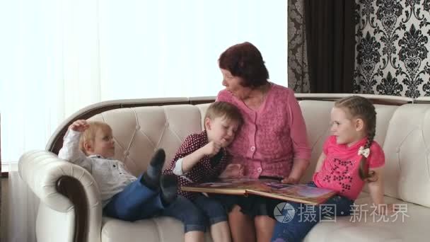 奶奶和孙子们一起看相册视频